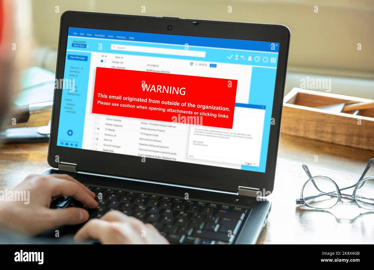Email attachments warning message on a laptop screen. Computer Virus and Antivirus. Cyber security concept. Stock Photo