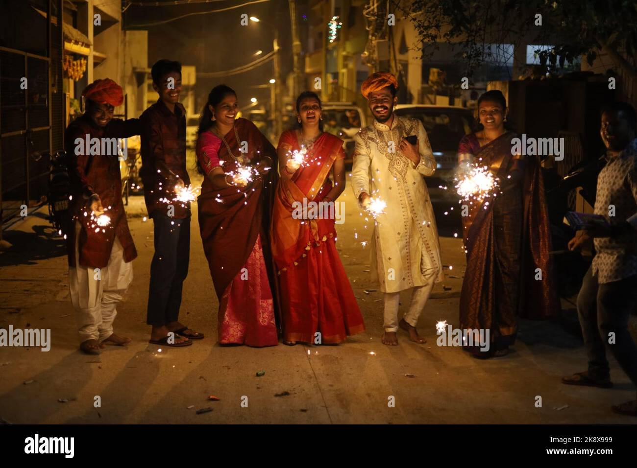Bangalore, India. 24th Oct, 2022. People light firecrackers to