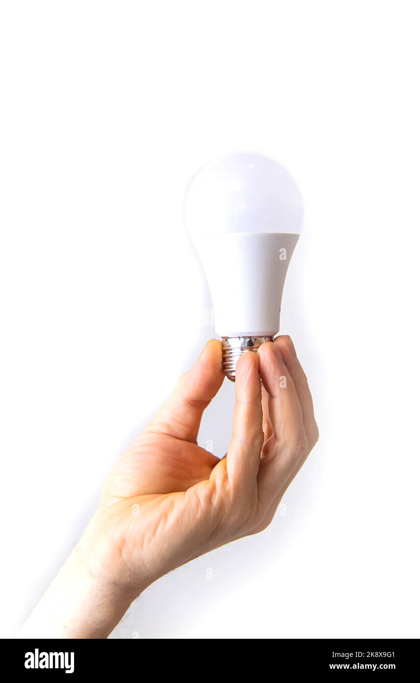 Hand installing led light bulb Cut Out Stock Images & Pictures - Alamy