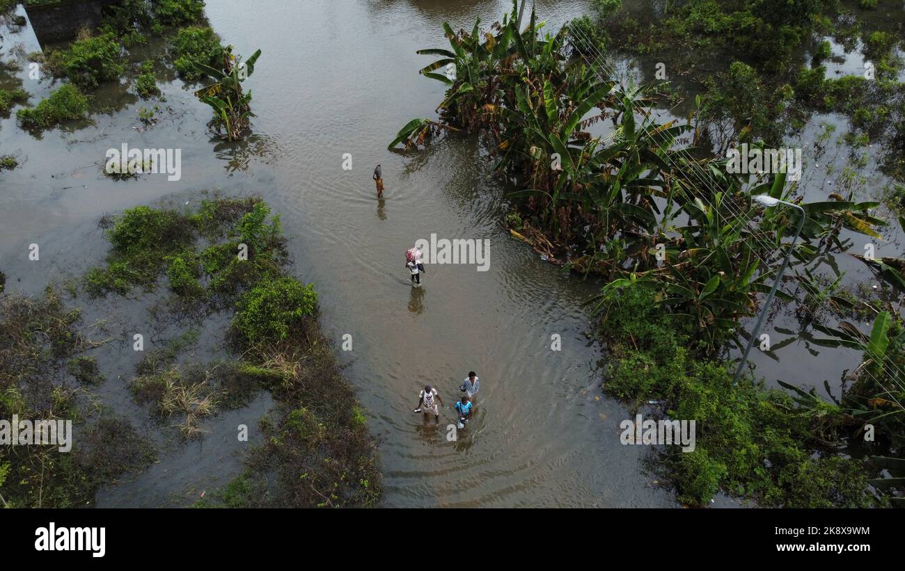 Residents wade through flood water in Obagi community in Ahoada, Rivers state, Nigeria October 22, 2022. REUTERS/Temilade Adelaja Stock Photo