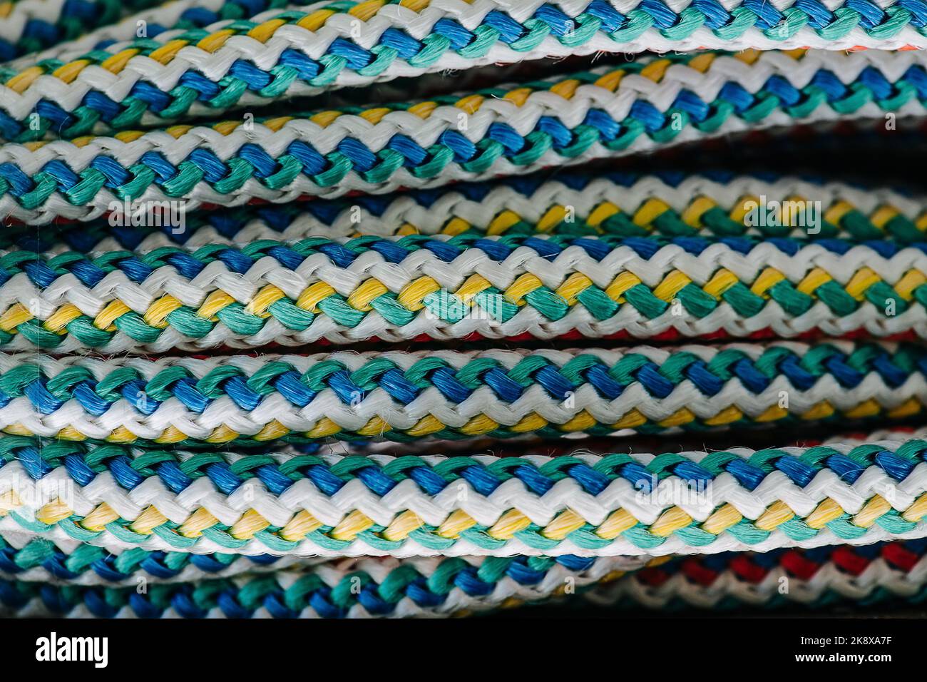 Winded parallel colorful rope close up. Blue, green, yellow and white