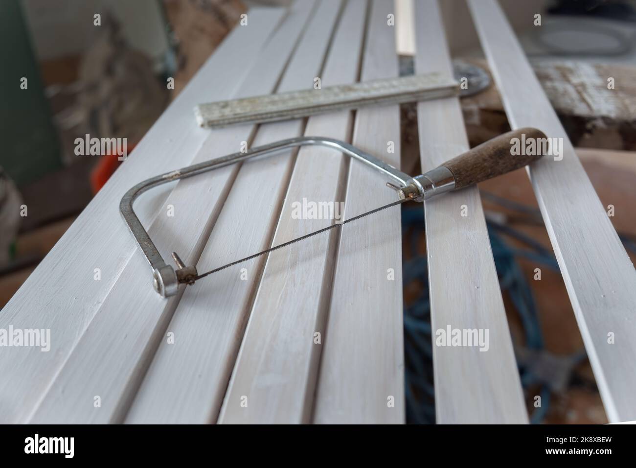 Hand saw and ruler on wood planks. Home renovation project. Stock Photo