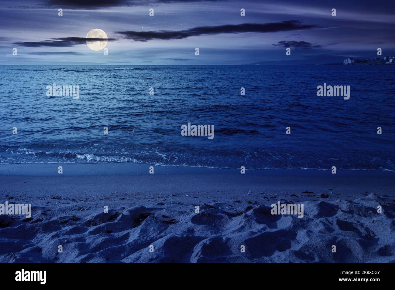 minimalistic seascape in summer at night. beach sea and horizon in full moon light. purity in nature Stock Photo