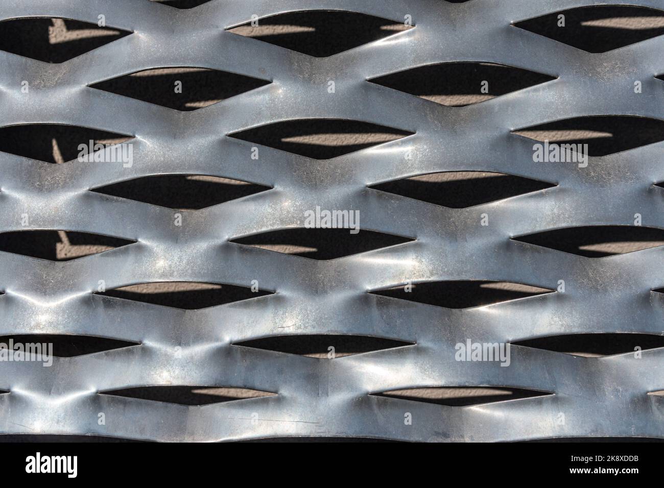 Perforated metal sheet stamping plate texture front view. Light reflection and shadow Stock