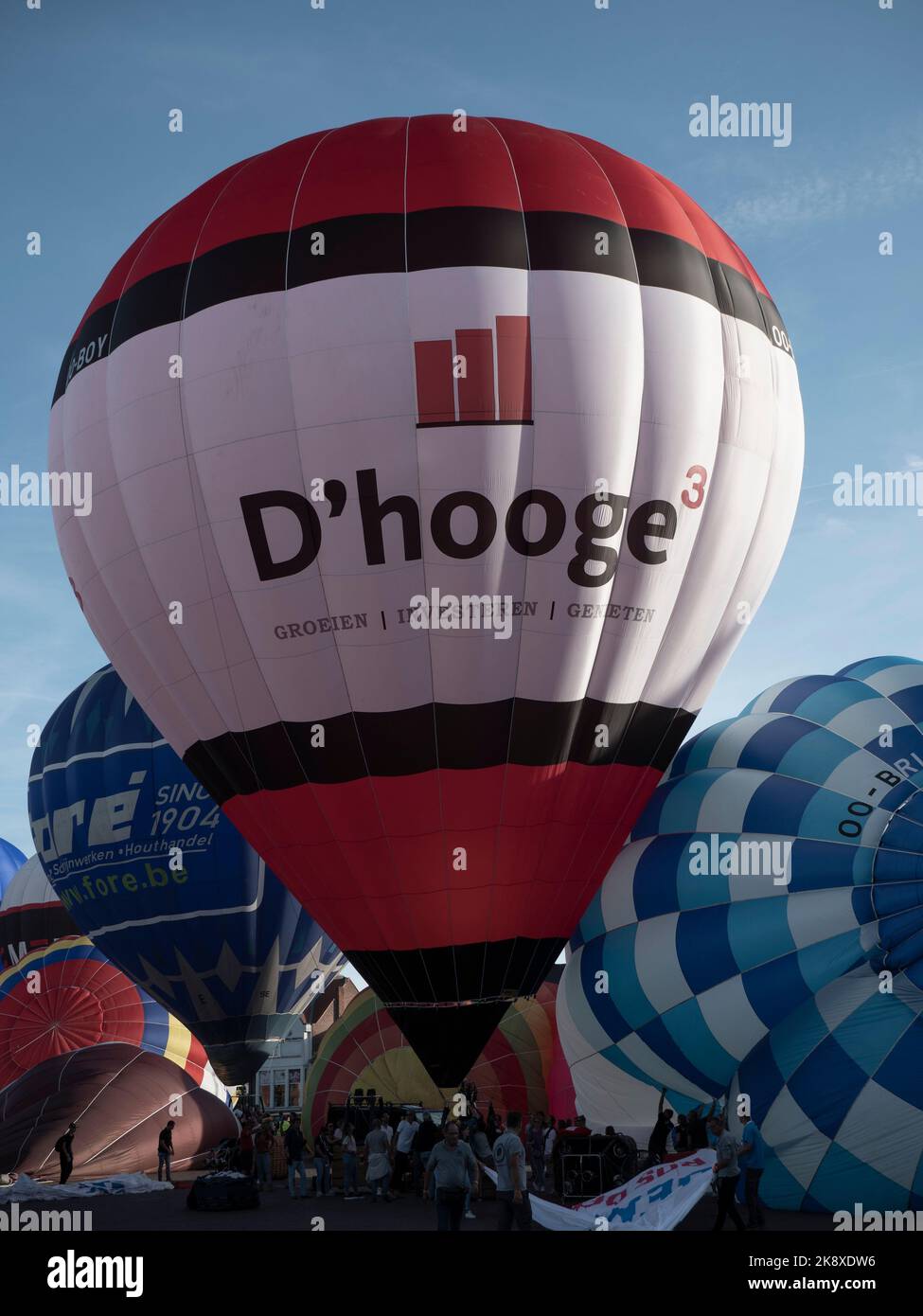 Sint Niklaas, Belgium, September 04, 2022, D'hooge hot air balloon is inflated among many other balloons Stock Photo