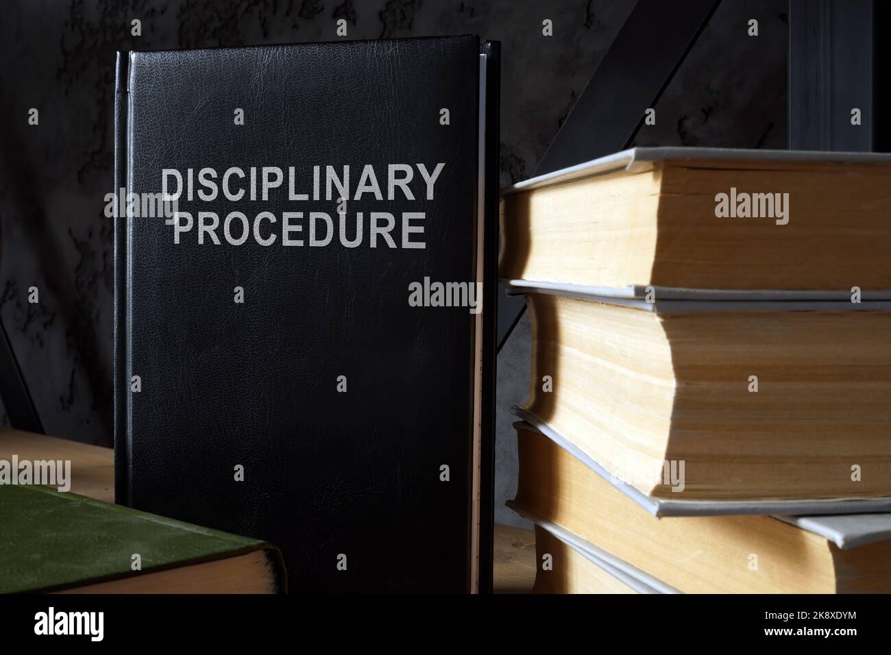 The book disciplinary procedure is on the shelf. Stock Photo