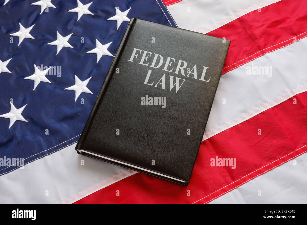Federal law book is on the US flag. Stock Photo