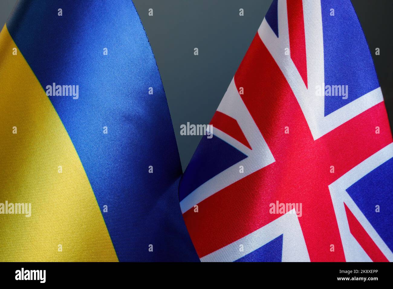 Nearby are the flags of Ukraine and Great Britain as symbols of diplomacy and support. Stock Photo