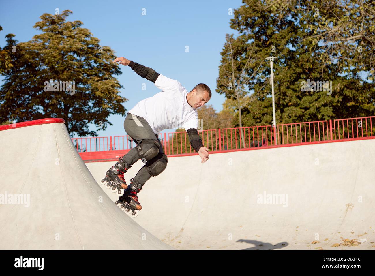 Energetic man on roller skates in motion at modern roller skate park