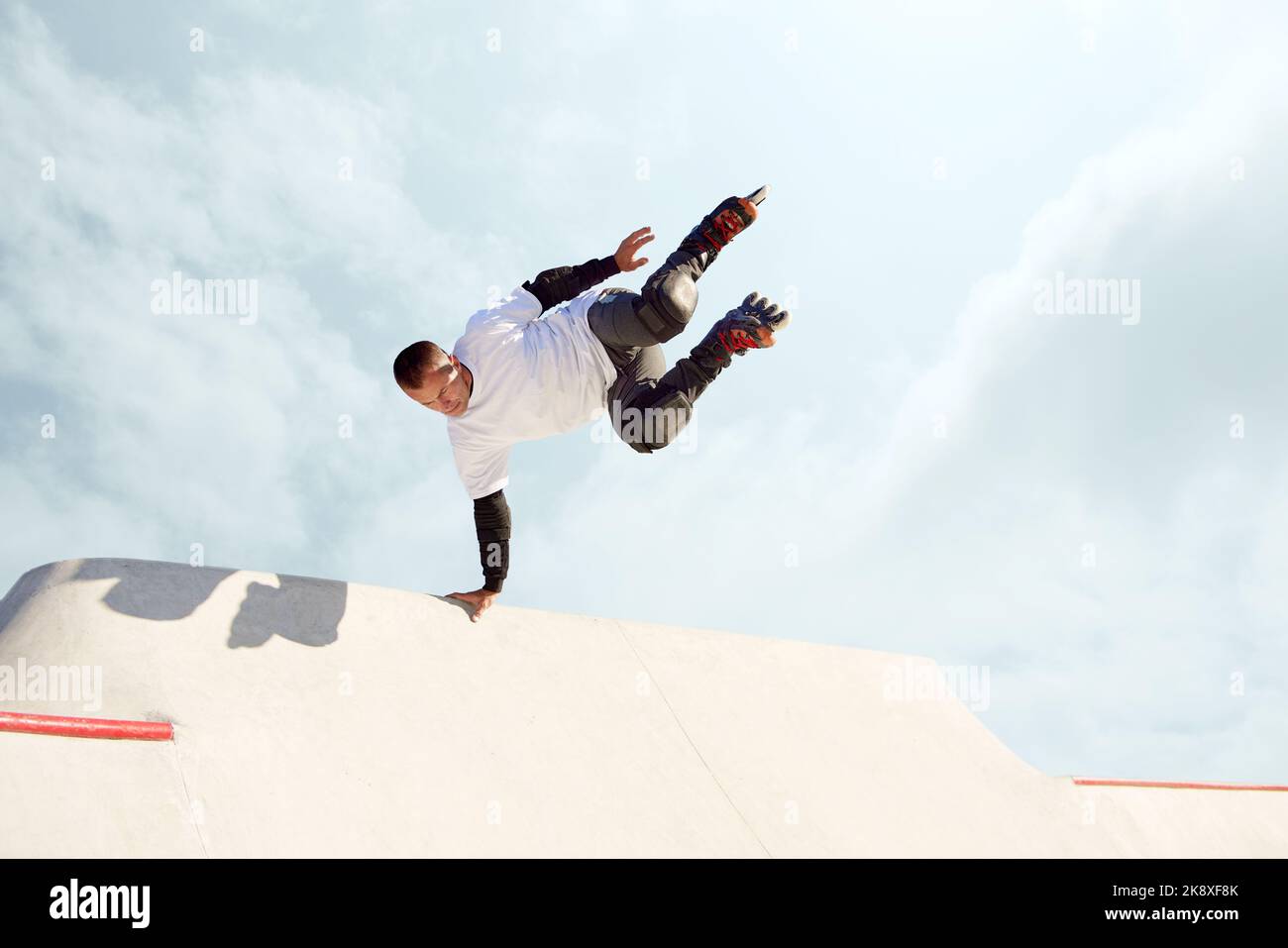 Energetic man on roller skates in motion at modern roller skate park