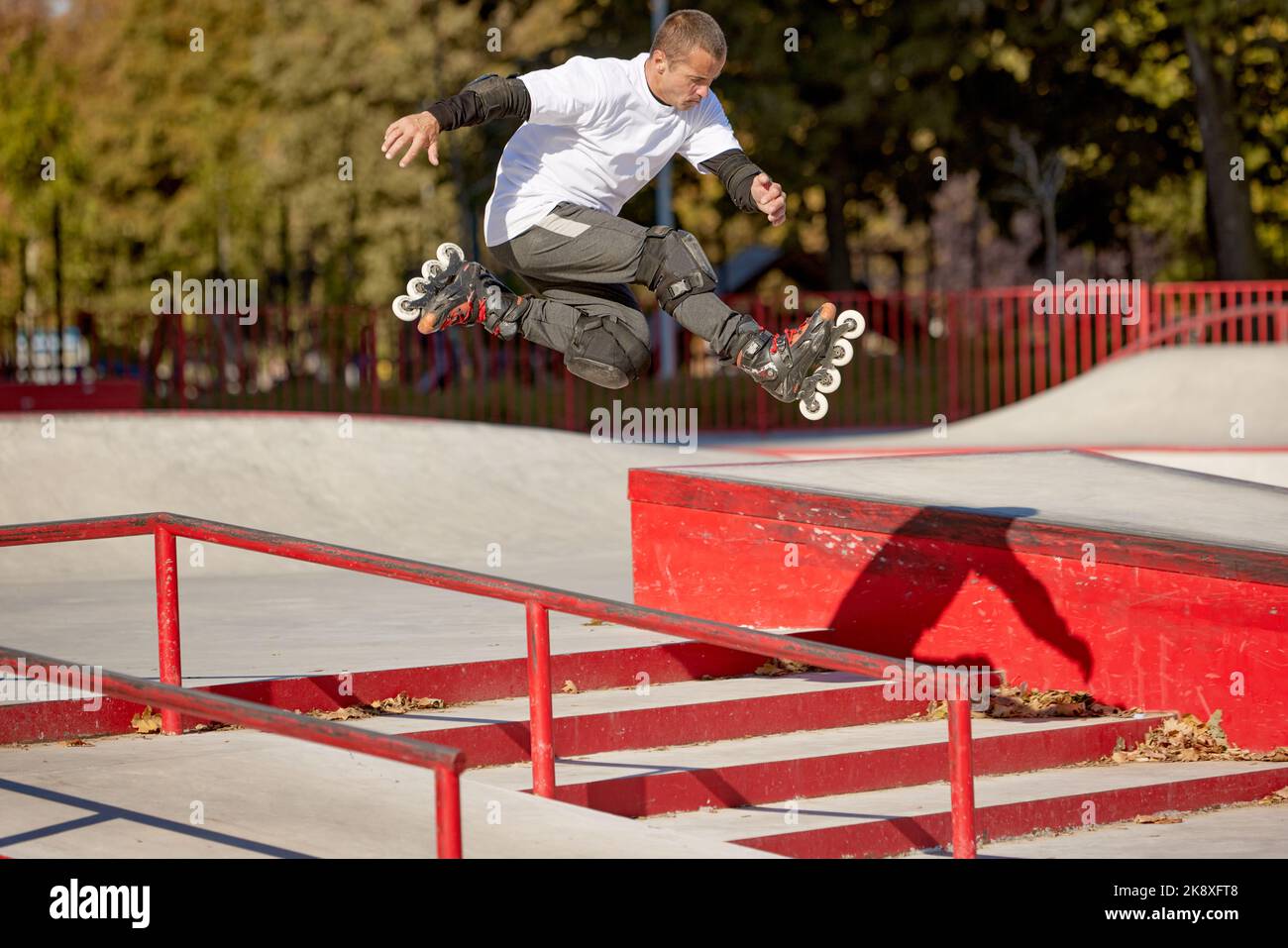 Trick on ramp. Energetic man on roller skates in motion at modern roller  skate park. Roller skater doing dangerous and daring tricks. Sport, health  Stock Photo - Alamy