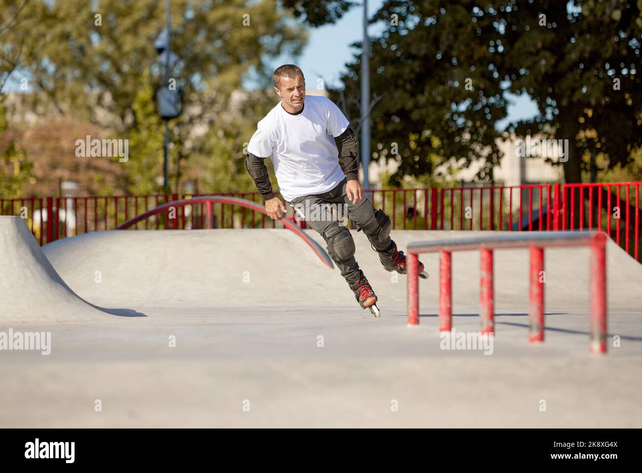 Energetic man on roller skates in motion at modern roller skate park