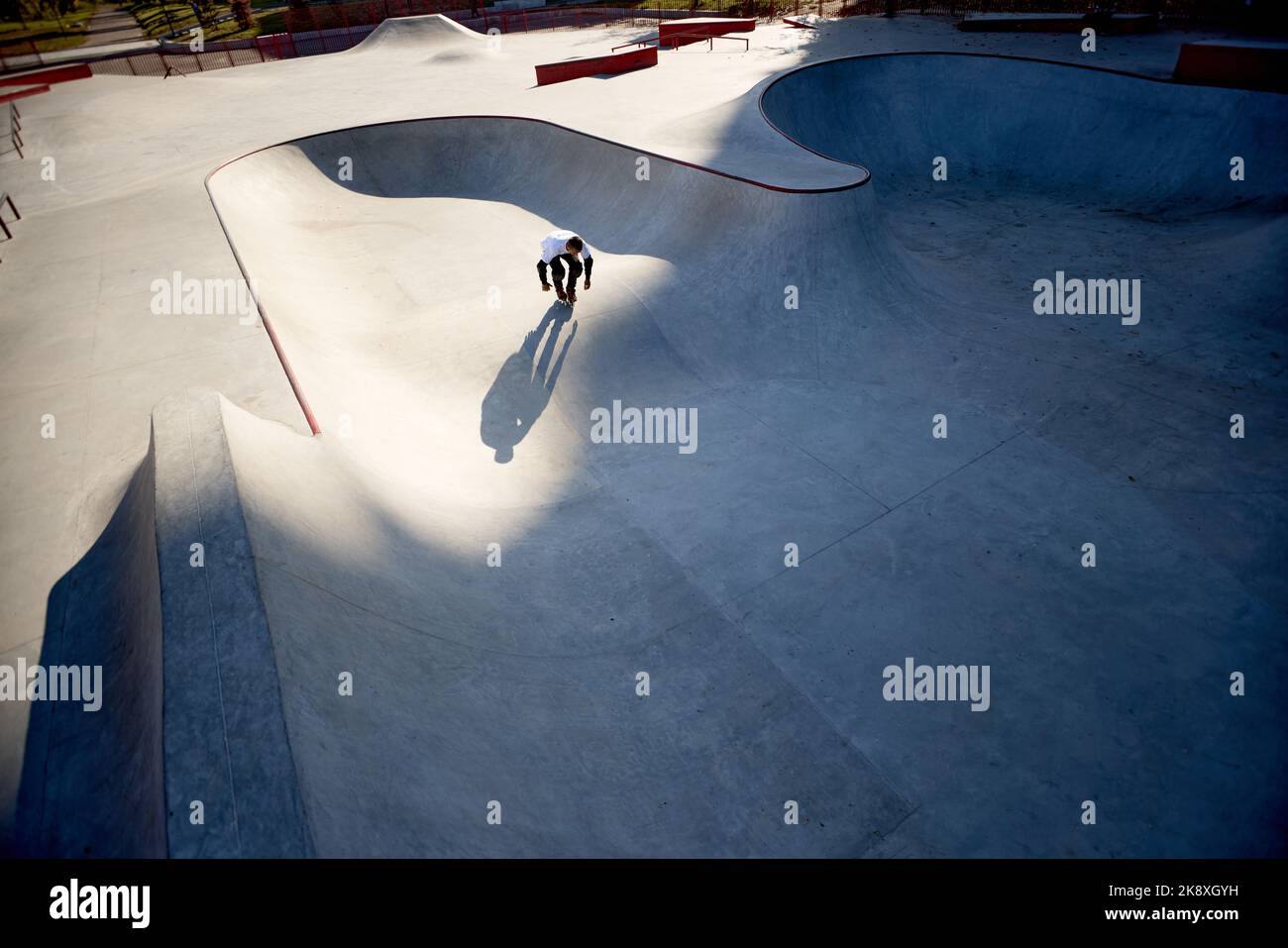 Aerial view of man, male roller skater on rollerblades training at