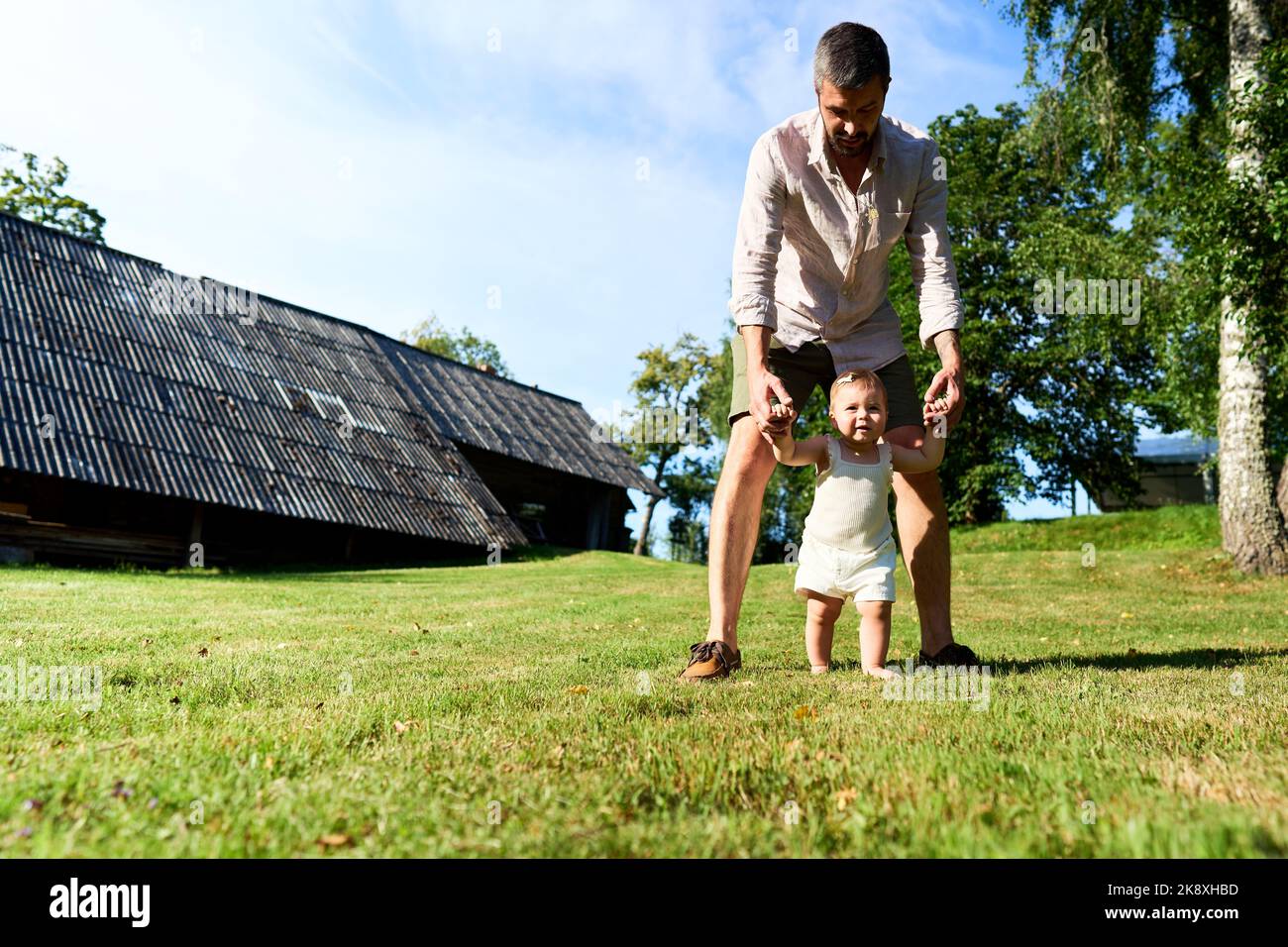 Father teaching baby to walk hi-res stock photography and images - Alamy