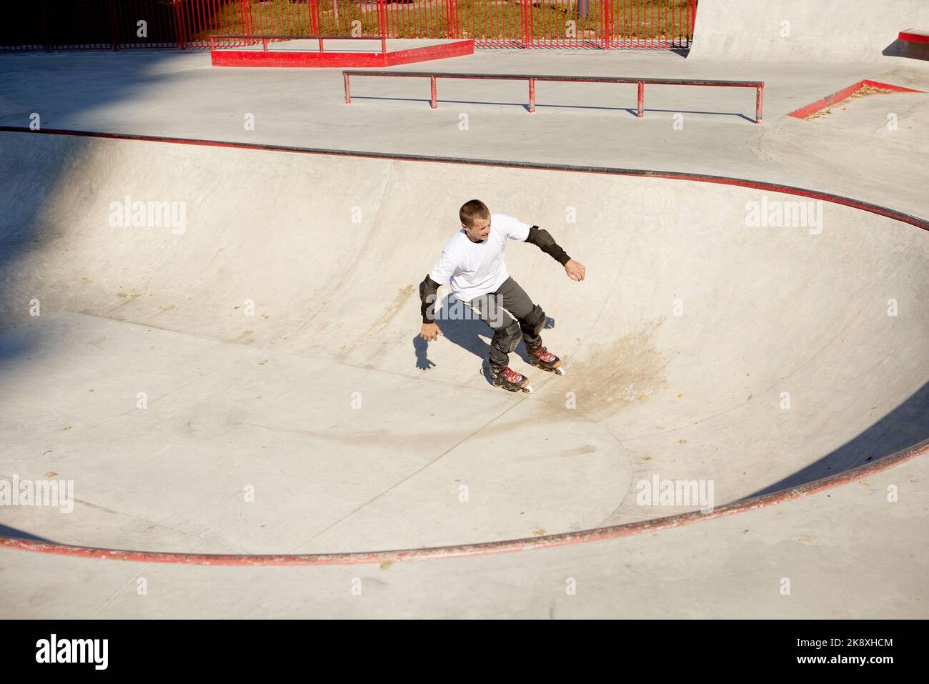 Energetic man on roller skates in motion at modern roller skate park