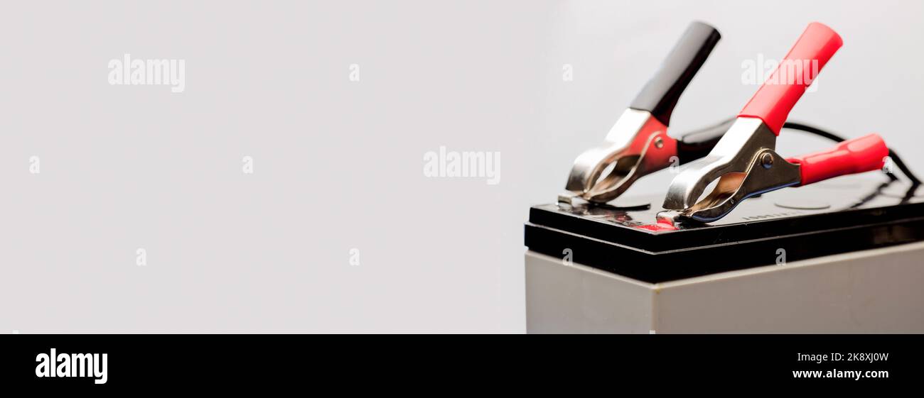 connected bolts charging battery positive pole and negative pole, white