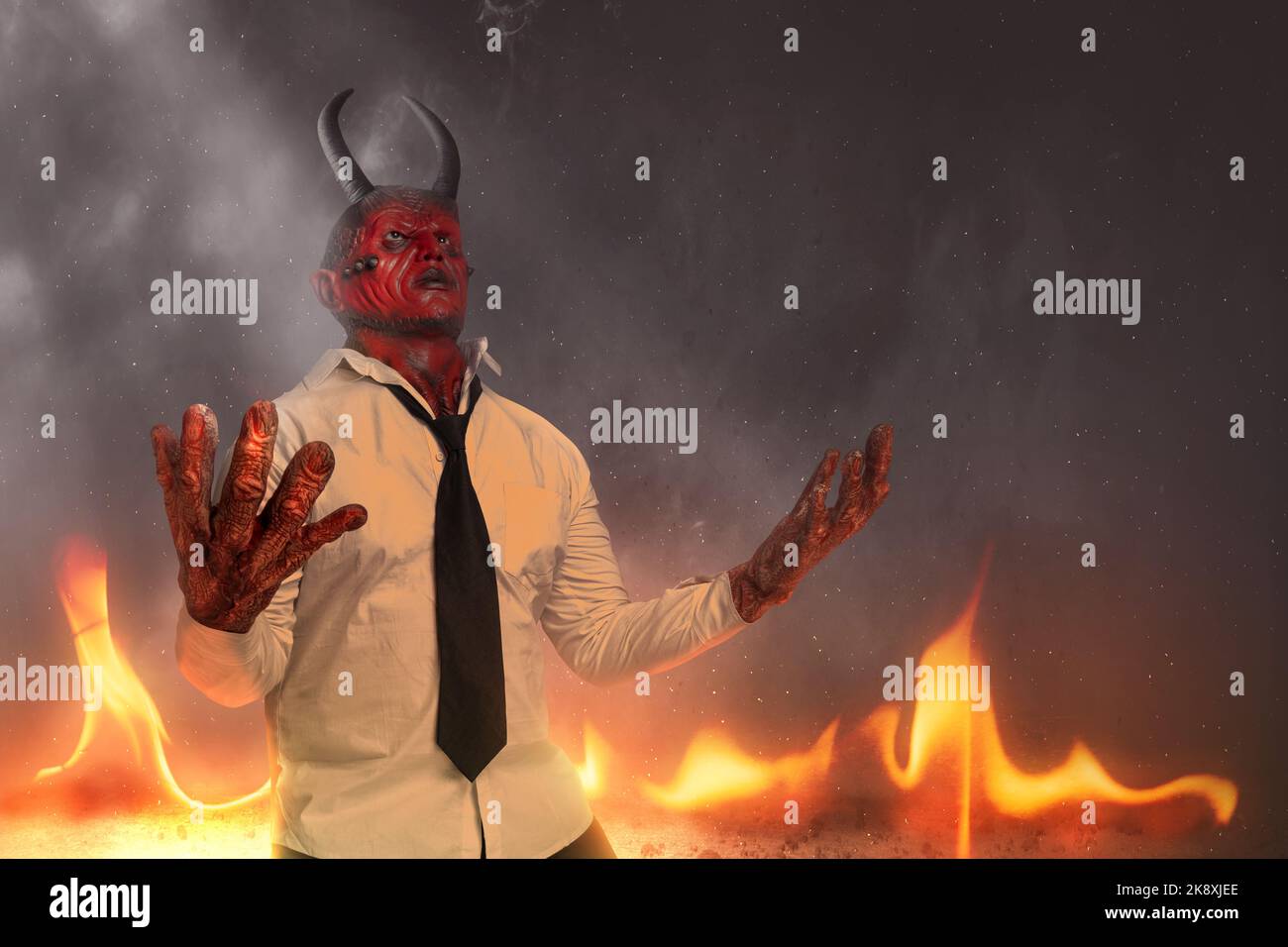 Devilman is standing with fire's background. Halloween concept Stock Photo