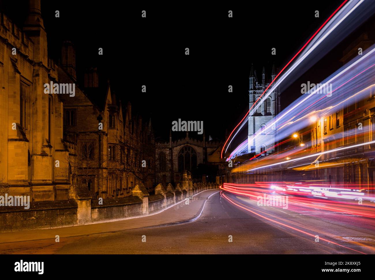 Traffic light trails past Oxford University college buildings on High Street. Stock Photo