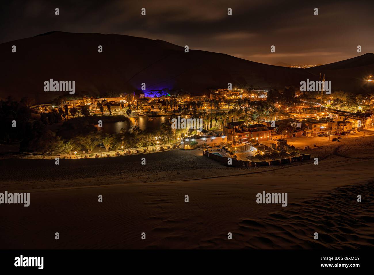 Wide angle long exposure of the desert oasis of Huacachina in Peru at night. Stock Photo