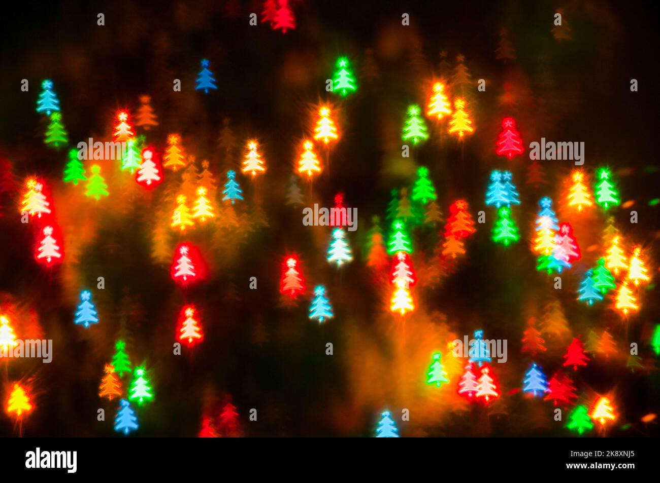 Christmas festive background, holiday Christmas glowing color lights with shining Christmas tree Stock Photo