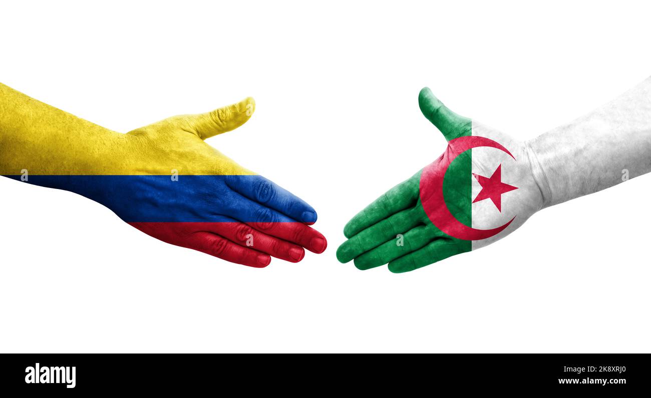 Handshake between Algeria and Colombia flags painted on hands, isolated transparent image. Stock Photo