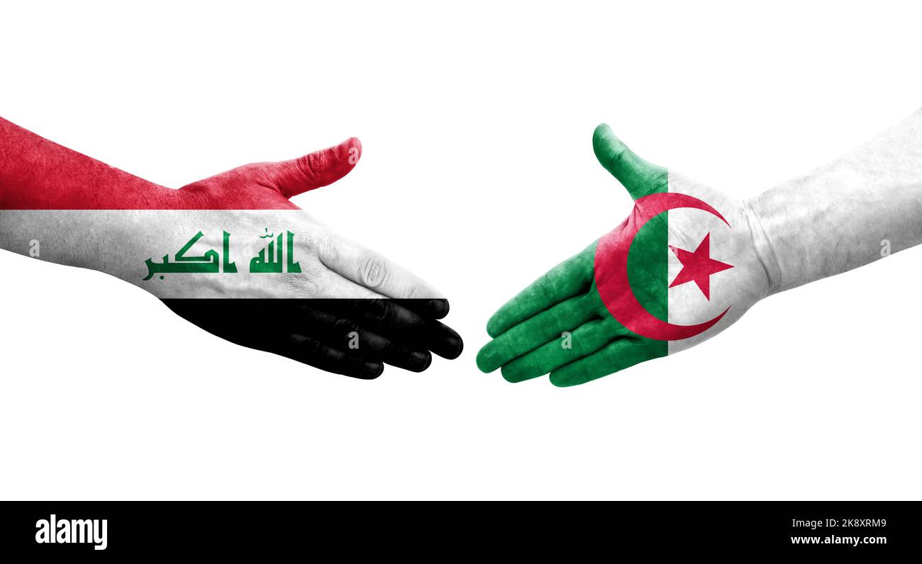 Handshake between Algeria and Iraq flags painted on hands, isolated transparent image. Stock Photo