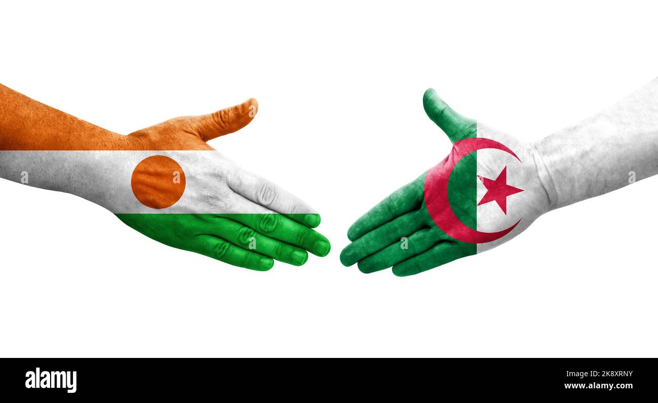 Handshake between Algeria and Niger flags painted on hands, isolated transparent image. Stock Photo