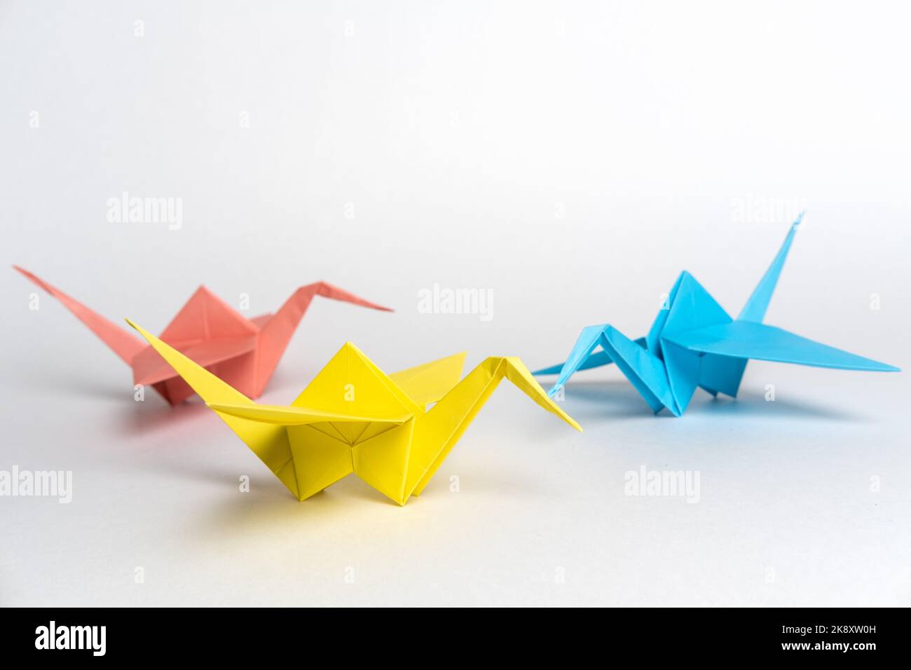 Traditional Japanese origami cranes made of paper on a white background