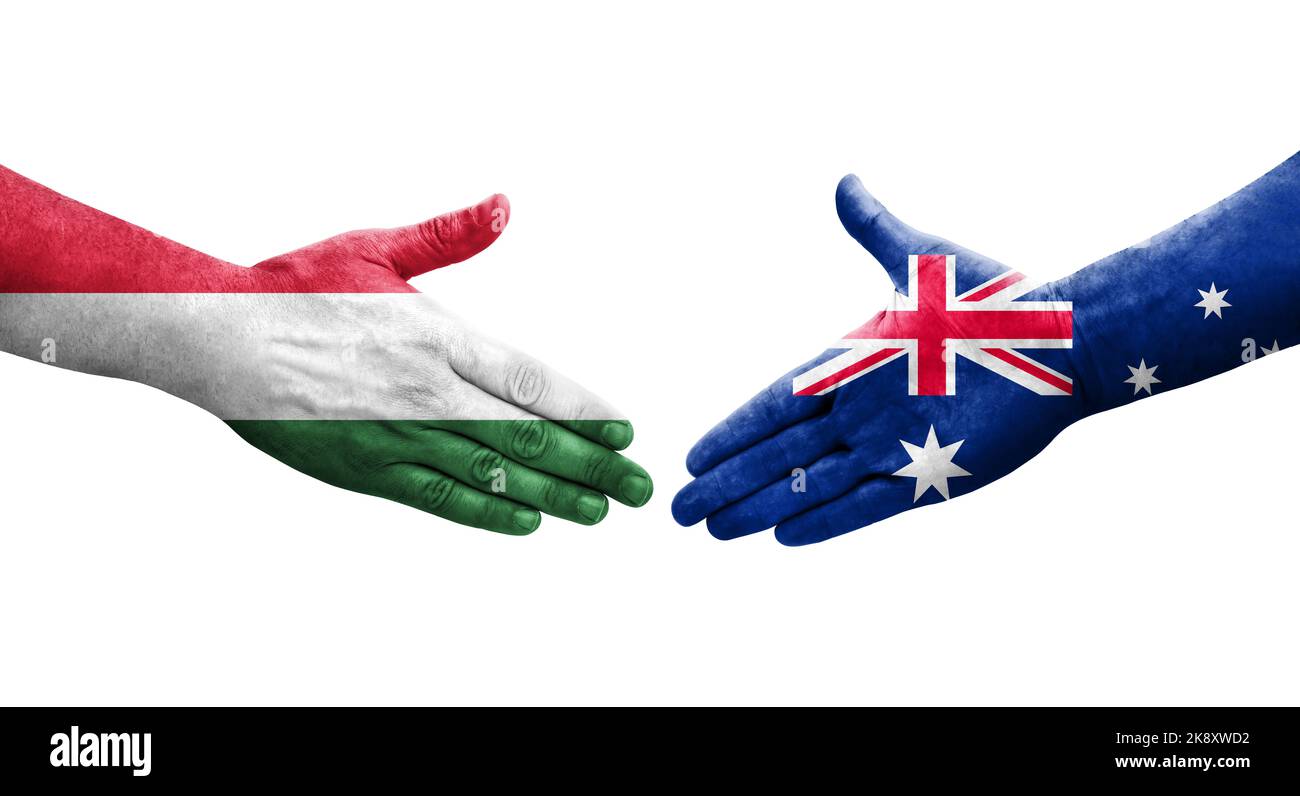 Handshake between Australia and Hungary flags painted on hands, isolated transparent image. Stock Photo