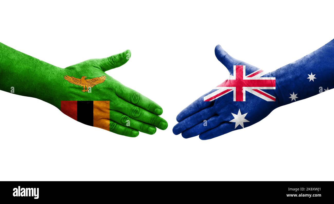 Handshake between Australia and Zambia flags painted on hands, isolated transparent image. Stock Photo