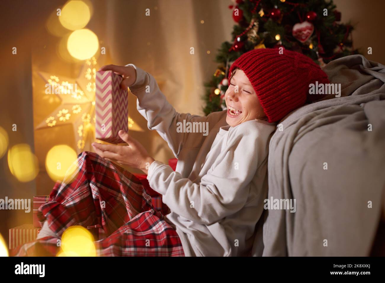 Kid opening gifts presents Happy reaction to Christmas New Year card adorable character Gifts giving Stock Photo