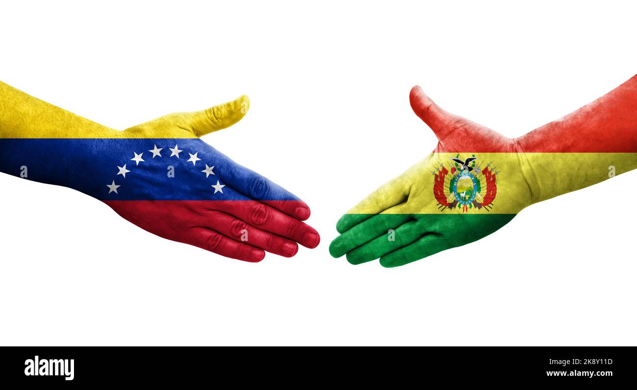 Handshake between Bolivia and Venezuela flags painted on hands, isolated transparent image. Stock Photo