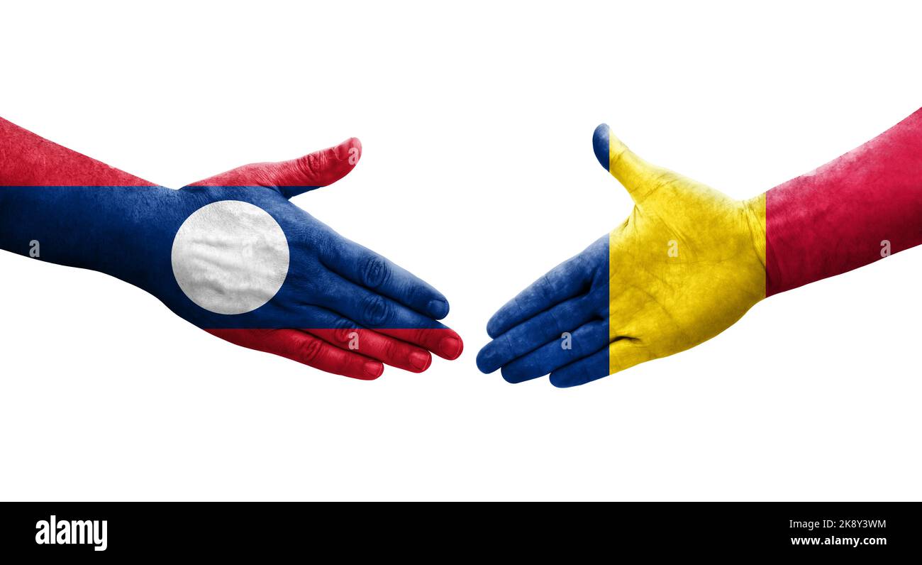 Handshake between Chad and Laos flags painted on hands, isolated transparent image. Stock Photo