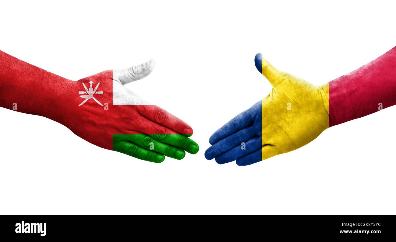 Handshake between Chad and Oman flags painted on hands, isolated transparent image. Stock Photo