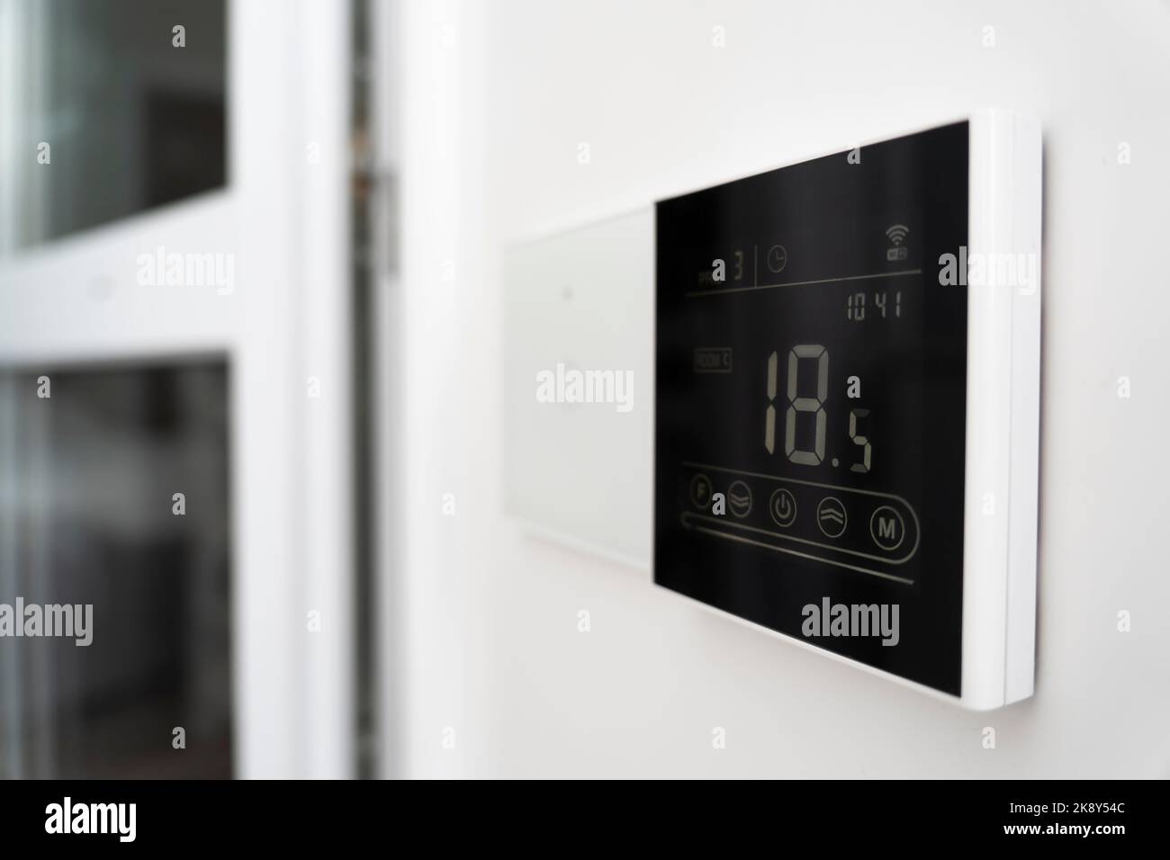 air conditioner screen on the wall that shows an air temperature of 18