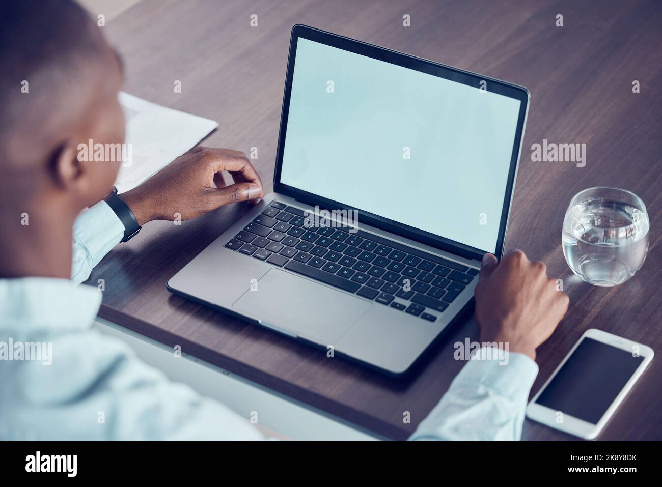 Mockup screen, advertising and businessman on a laptop for business, networking and communication in an office at work. Computer of corporate worker Stock Photo