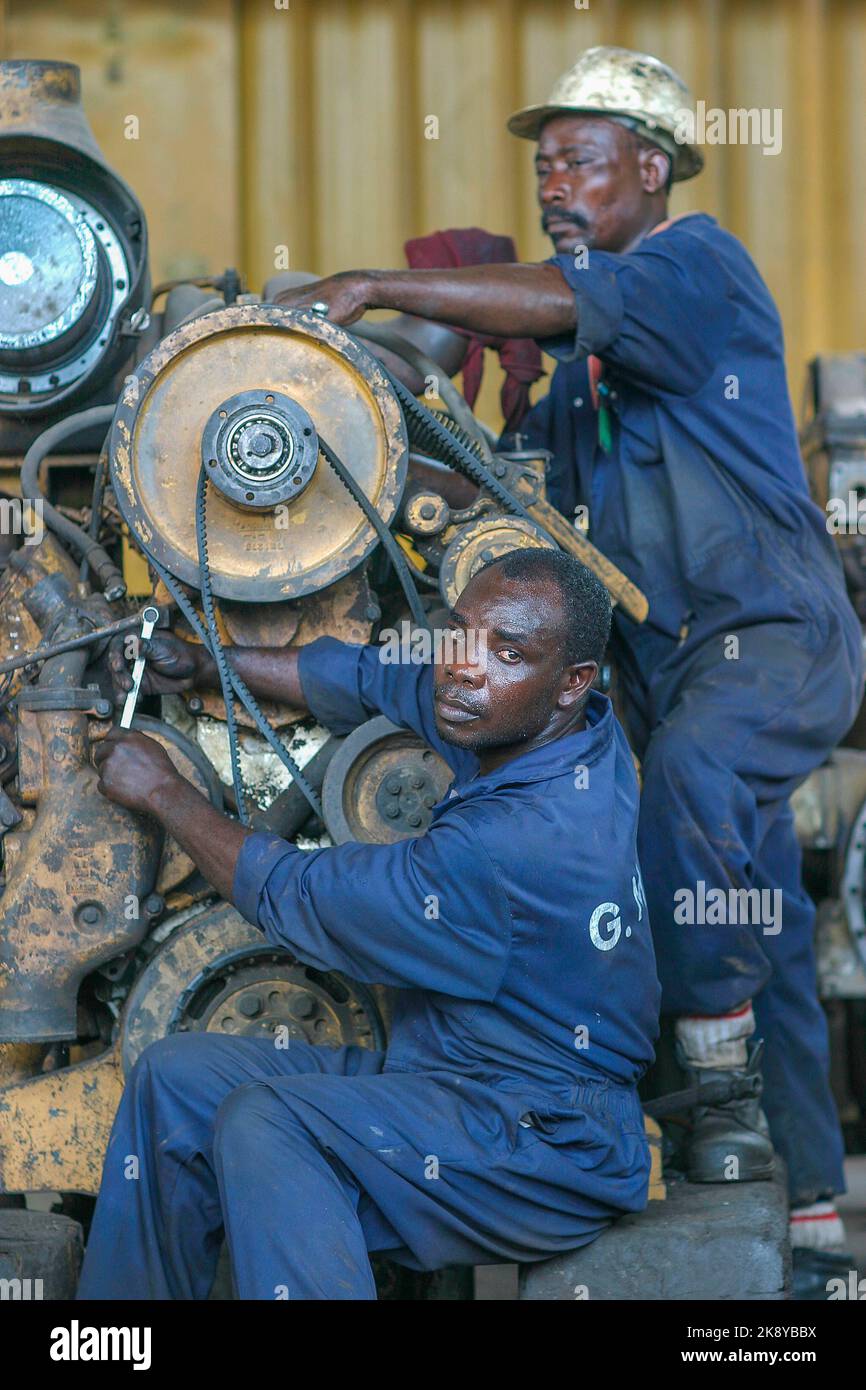 Ghana, Takoradi. Mechanics of Manganese mining company repair a motor