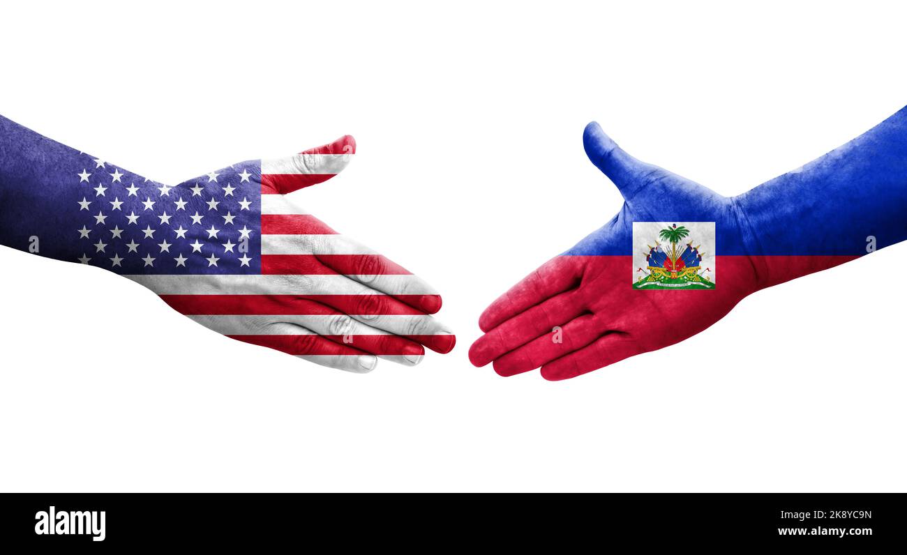 Handshake between Haiti and USA flags painted on hands, isolated transparent image. Stock Photo