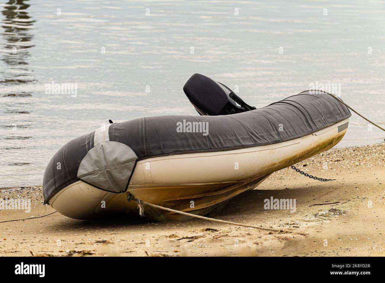A closeup of inflatable boat with motor parked in beach Stock Photo Alamy