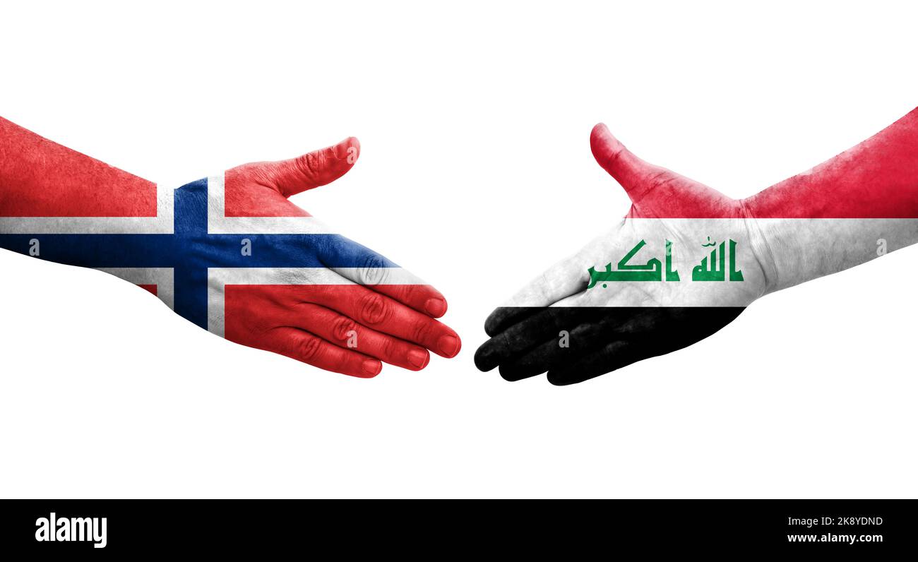 Handshake between Iraq and Norway flags painted on hands, isolated transparent image. Stock Photo