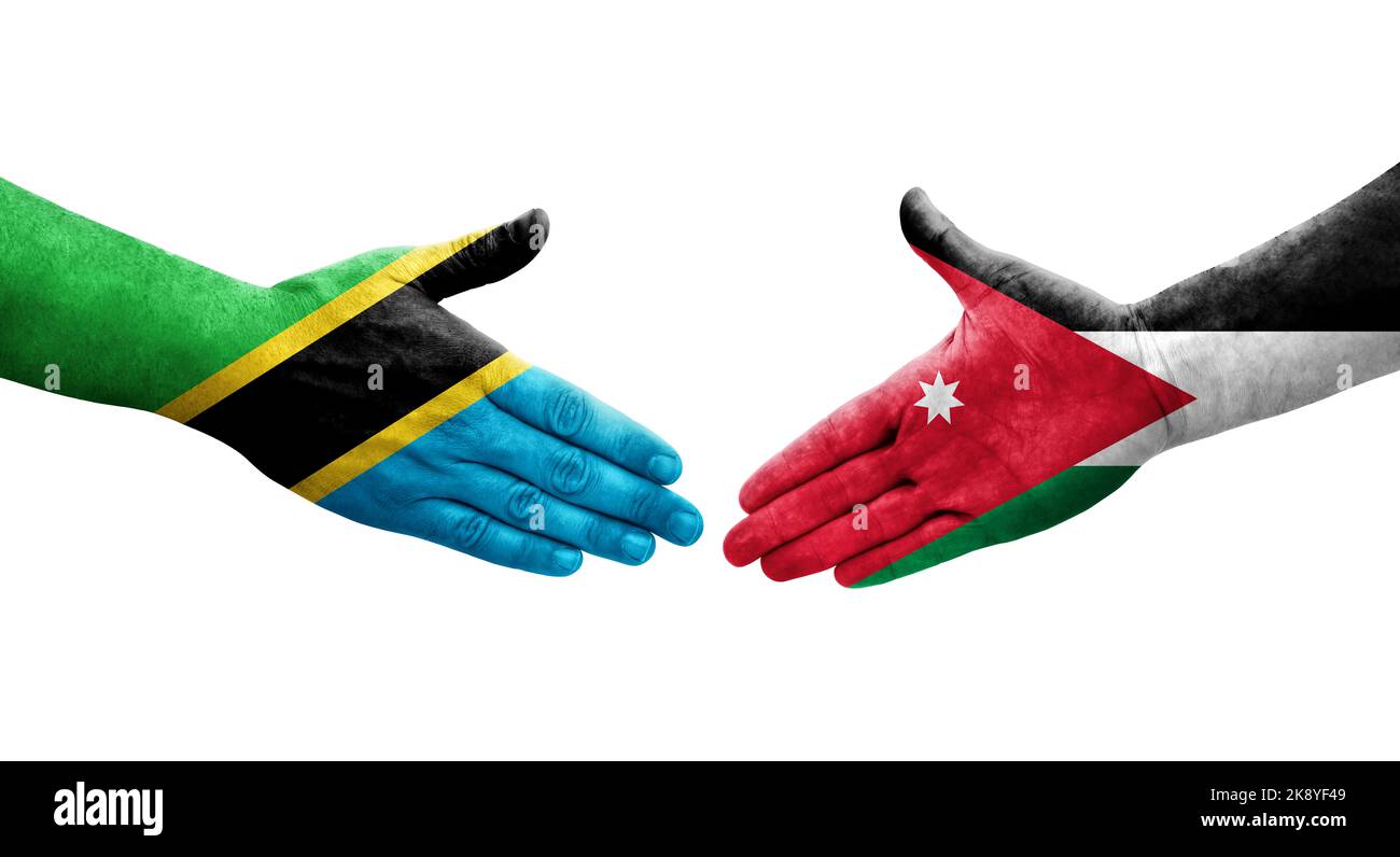 Handshake between Jordan and Tanzania flags painted on hands, isolated transparent image. Stock Photo