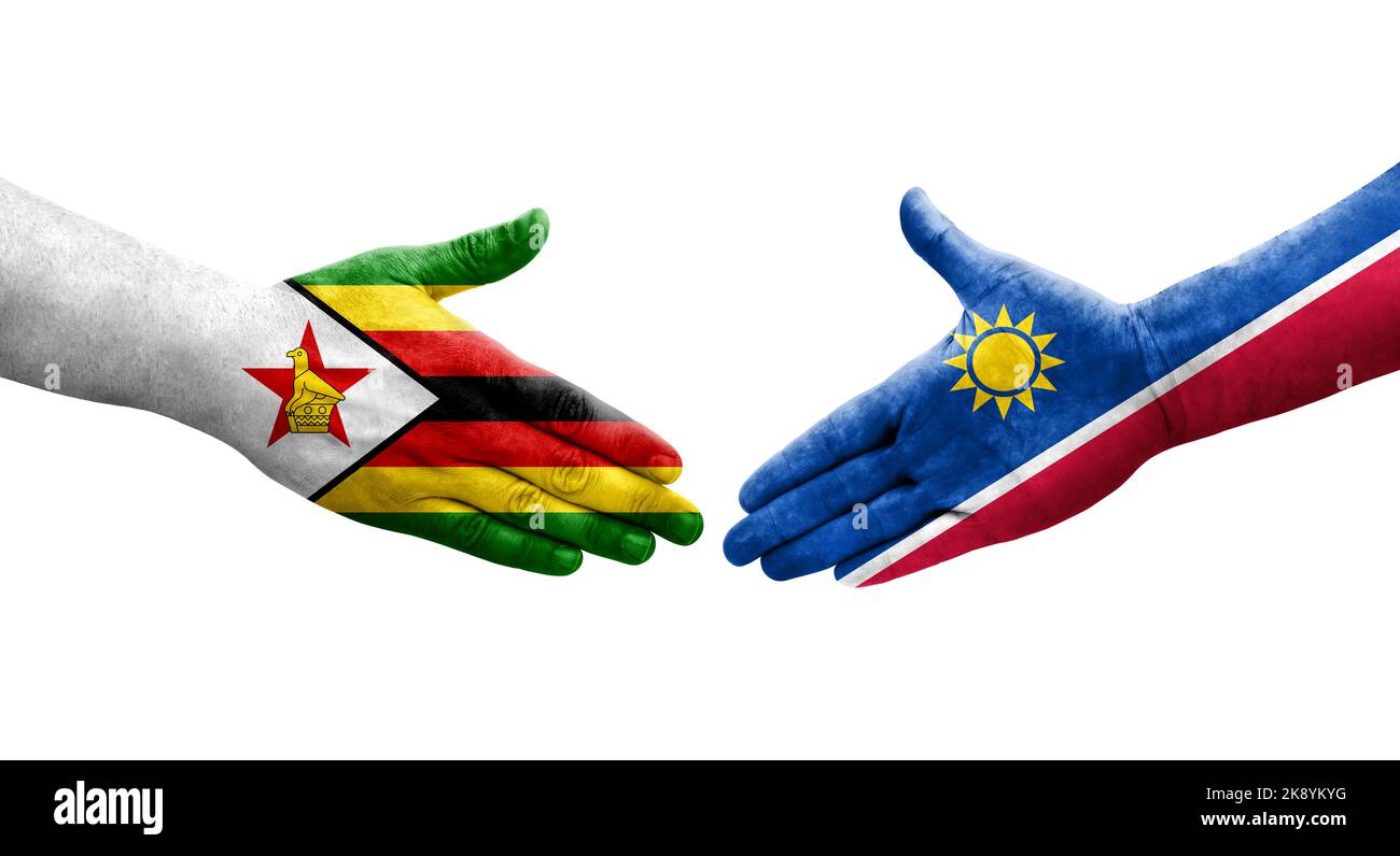 Handshake between Namibia and Zimbabwe flags painted on hands, isolated