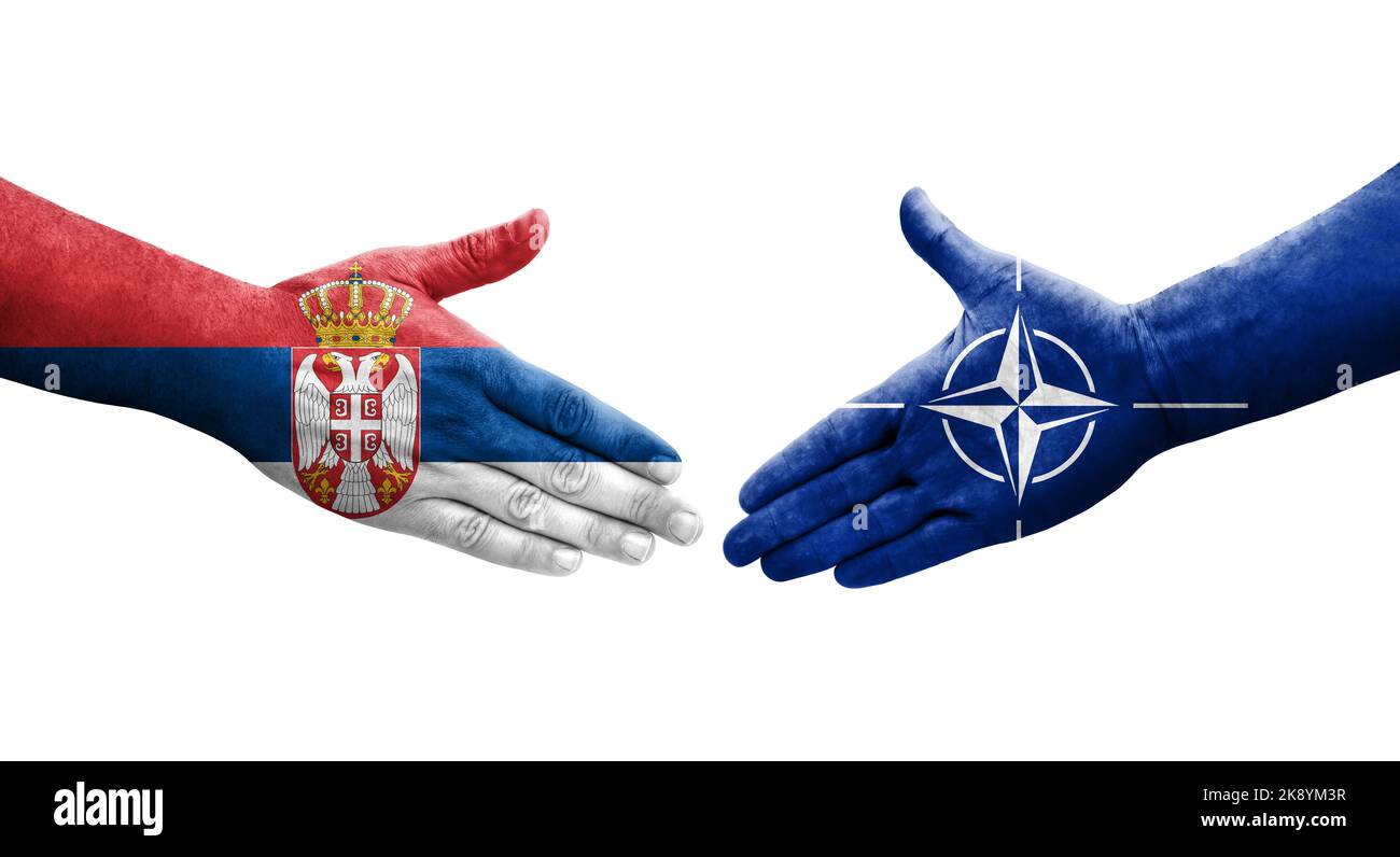 Handshake between Nato and Serbia flags painted on hands, isolated transparent image. Stock Photo