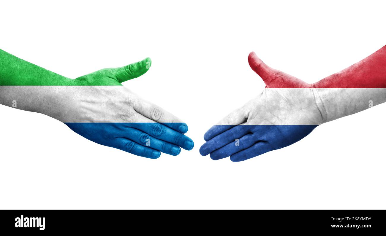 Handshake between Netherlands and Sierra Leone flags painted on hands, isolated transparent image. Stock Photo