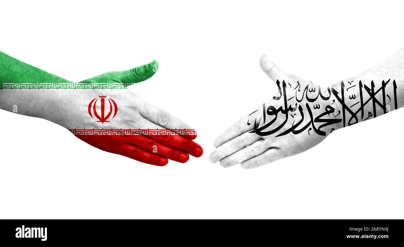 Handshake between Palestine and Iran flags painted on hands, isolated transparent image. Stock Photo