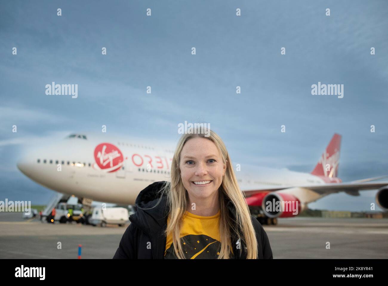 A delighted Melissa Thorpe, Director of Spaceport Cornwall standing in front of Virgin Orbit, Cosmic Girl a 747-400 converted rocket launch platform a Stock Photo