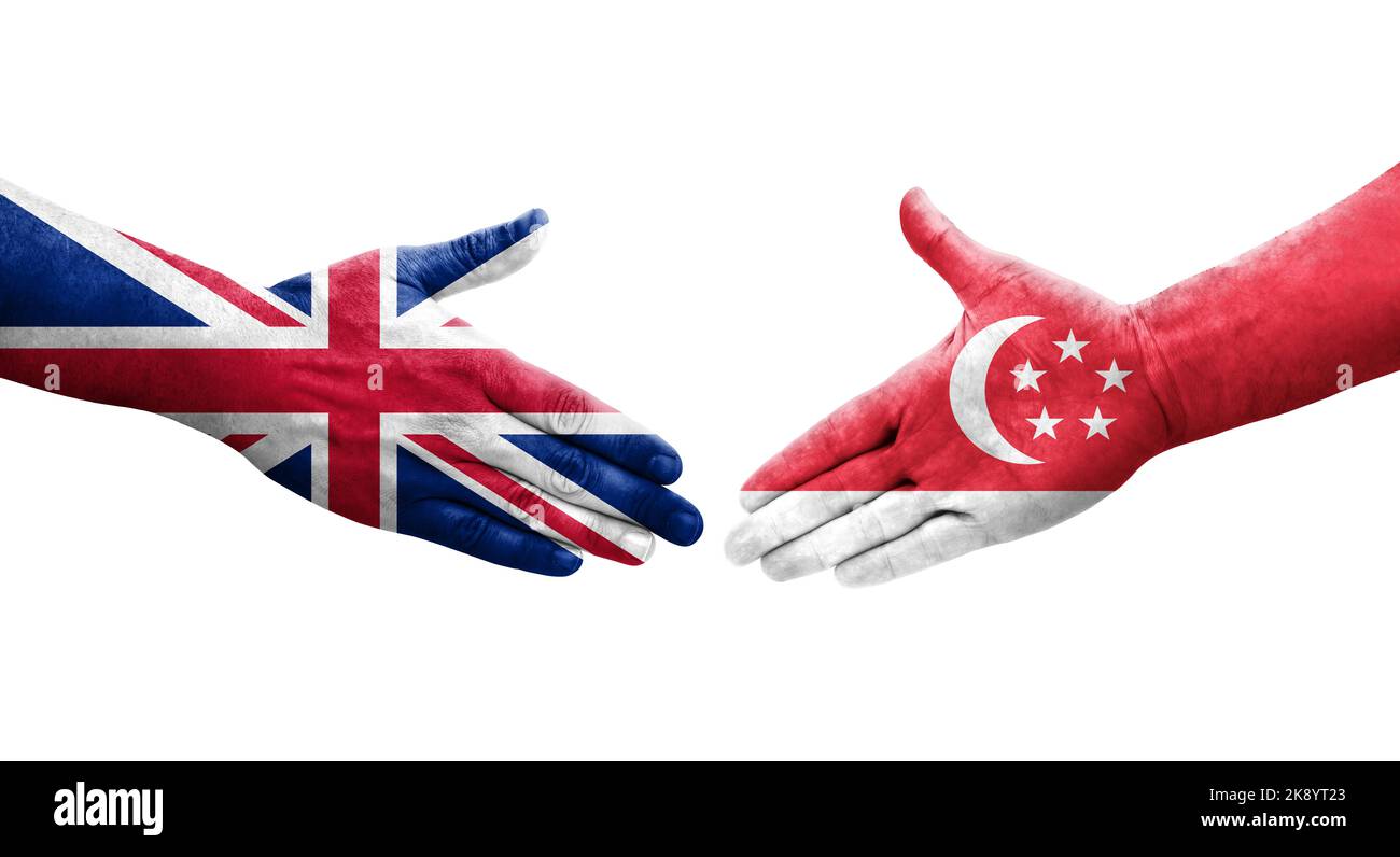 Handshake between Singapore and United Kingdom flags painted on hands, isolated transparent image. Stock Photo