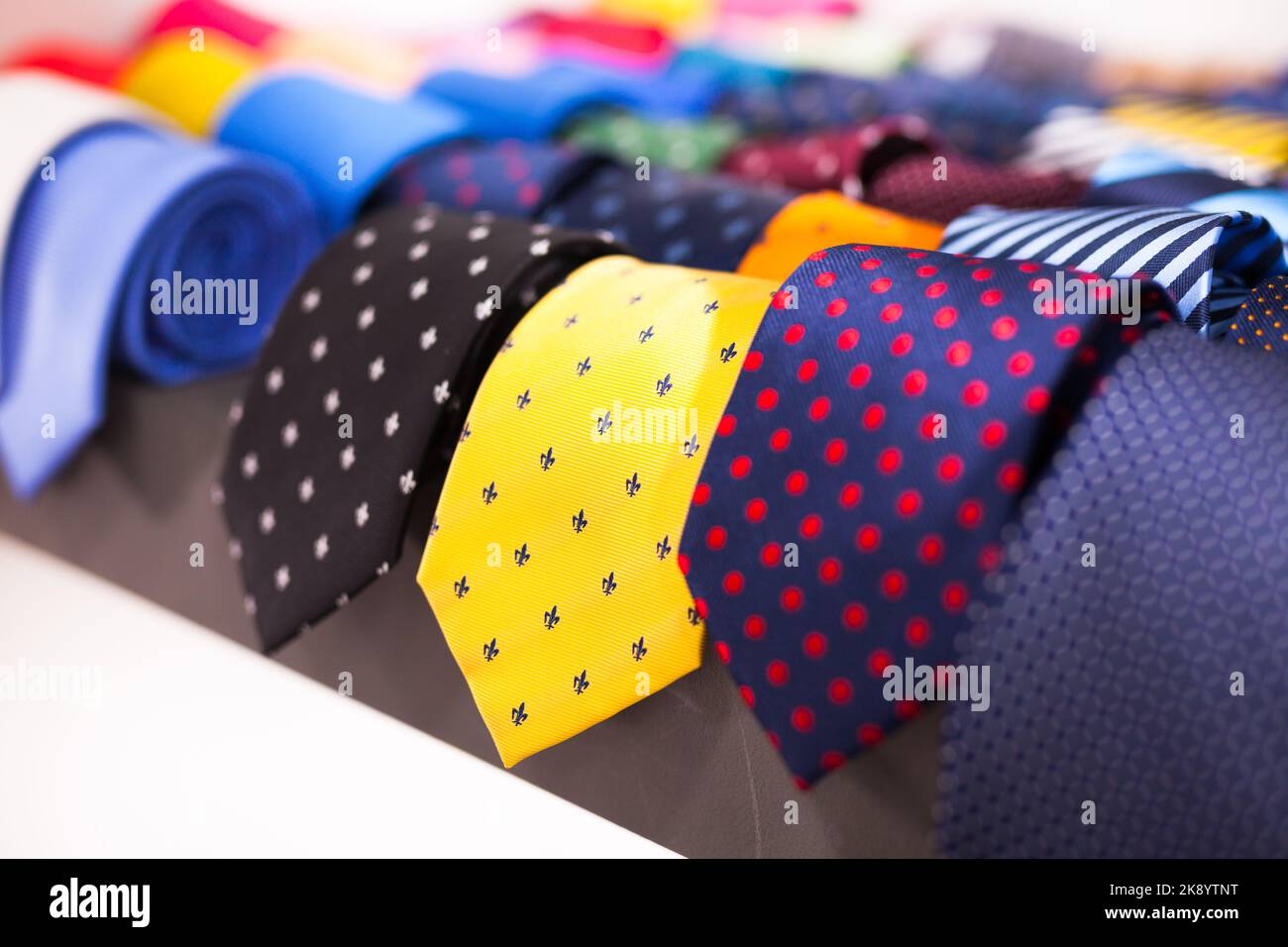 ties on hangers in men clothing store Stock Photo Alamy