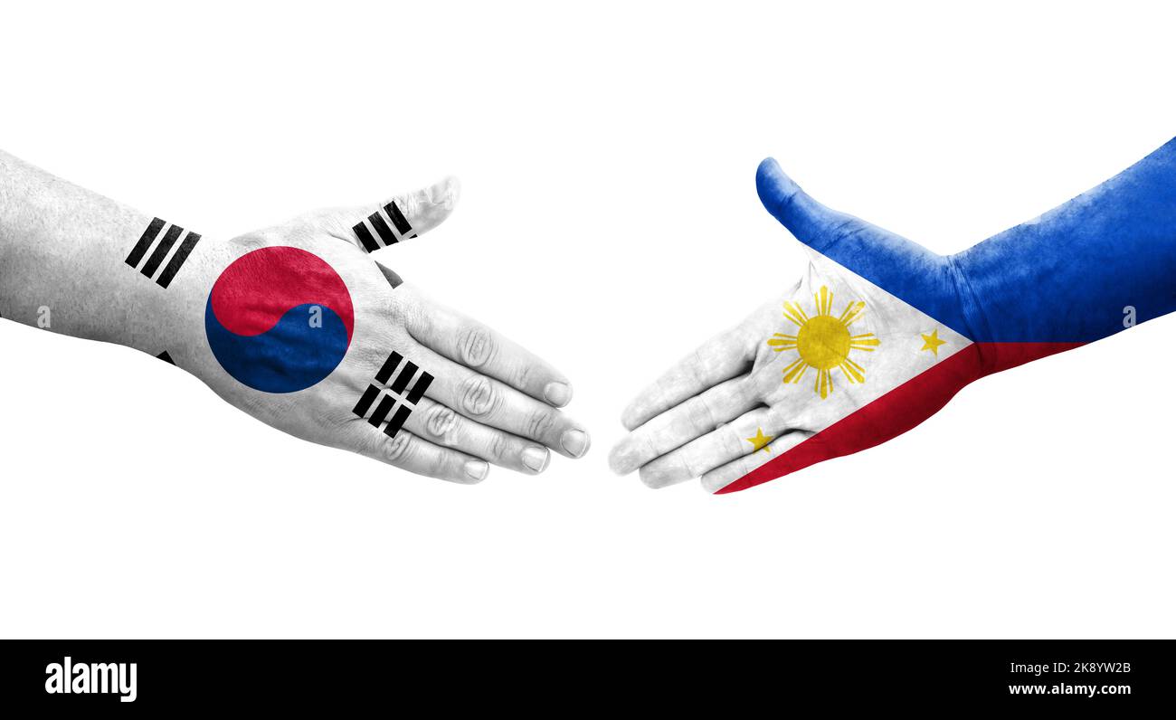 Handshake between South Korea and Philippines flags painted on hands, isolated transparent image