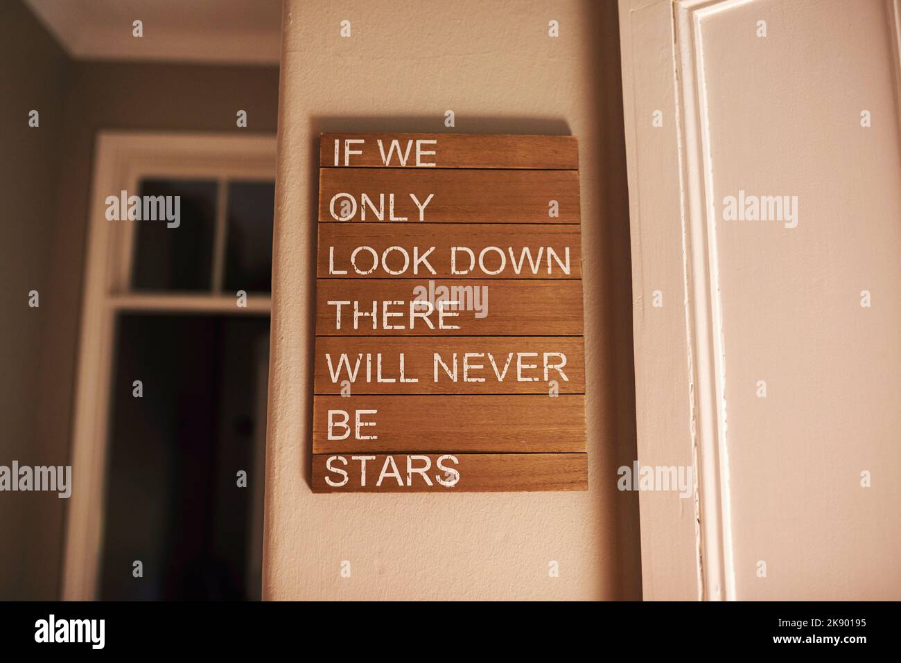 Keep your chin up. a motivational quote hanging on a wall Stock Photo